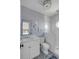 Stylish bathroom with a modern vanity, patterned tile floor, and a glass-enclosed shower with a round window at 3001 Marshall Blvd, Sullivans Island, SC 29482