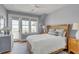 Cozy bedroom with a wicker bed frame, ocean view window, and light blue accents at 3001 Marshall Blvd, Sullivans Island, SC 29482