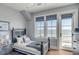 Comfortable bedroom featuring a dark wood frame bed, an ocean view window, and stylish decor at 3001 Marshall Blvd, Sullivans Island, SC 29482