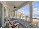 Spacious covered deck with lounge seating and stunning ocean views, perfect for relaxing outdoors at 3001 Marshall Blvd, Sullivans Island, SC 29482