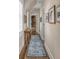 Inviting hallway featuring wood floors, shuttered windows and artwork leading to the bathroom at 3001 Marshall Blvd, Sullivans Island, SC 29482