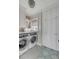 Bright laundry room with a front load washer/dryer and custom cabinetry at 3001 Marshall Blvd, Sullivans Island, SC 29482