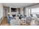 Bright and airy living room with ocean views, comfortable seating, and built-in shelving at 3001 Marshall Blvd, Sullivans Island, SC 29482