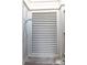 Enclosed outdoor shower area with slatted door and chrome fixtures at 3001 Marshall Blvd, Sullivans Island, SC 29482
