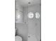 Shower with white subway tile, a frameless glass enclosure, and a unique round window at 3001 Marshall Blvd, Sullivans Island, SC 29482