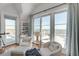 Bright sitting area featuring armchairs, coastal decor, and expansive ocean views from large sliding glass doors at 3001 Marshall Blvd, Sullivans Island, SC 29482