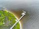 Breathtaking aerial perspective highlighting a charming pier, tranquil marsh, and expansive waterfront at 325 Blowing Fresh Dr, Charleston, SC 29492