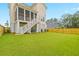 Backyard featuring a screened porch, stairs, green lawn, privacy fence and lovely backyard setting at 325 Blowing Fresh Dr, Charleston, SC 29492