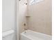Bathroom with a neutral-toned tiled shower featuring a built-in shelf, bathtub and shower combo at 325 Blowing Fresh Dr, Charleston, SC 29492