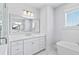 Elegant white bathroom with a large mirror, vanity, soaking tub, and stylish lighting at 325 Blowing Fresh Dr, Charleston, SC 29492