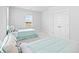 Bright bedroom featuring two twin beds with nautical decor, light blue linens and an abundance of natural light at 325 Blowing Fresh Dr, Charleston, SC 29492