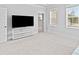 Bright, carpeted bedroom with a TV on a stand, a neutral color scheme, and plenty of natural light at 325 Blowing Fresh Dr, Charleston, SC 29492