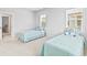 Bedroom with light blue nautical themed twin beds and plenty of natural light from two windows at 325 Blowing Fresh Dr, Charleston, SC 29492