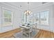 Charming dining area featuring natural light, modern chandelier, and stylish decor at 325 Blowing Fresh Dr, Charleston, SC 29492