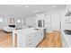 Open concept kitchen with a large island, stainless steel appliances, and seamless flow to living room at 325 Blowing Fresh Dr, Charleston, SC 29492