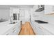 Gourmet kitchen with white cabinetry, stainless steel appliances, and a spacious island perfect for entertaining at 325 Blowing Fresh Dr, Charleston, SC 29492