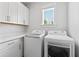 Bright laundry room featuring white cabinets, counterspace, and modern LG washer and dryer at 325 Blowing Fresh Dr, Charleston, SC 29492