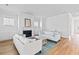 Spacious living room with white sofas, a fireplace, and wood floors, creating an inviting atmosphere at 325 Blowing Fresh Dr, Charleston, SC 29492