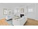 Bright and airy living room with a cozy fireplace, modern sofas, and natural light at 325 Blowing Fresh Dr, Charleston, SC 29492