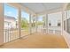 Relaxing screened-in porch with wood flooring and views of the surrounding neighborhood at 325 Blowing Fresh Dr, Charleston, SC 29492