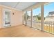 Spacious screened-in porch with wood flooring, offering beautiful views of the neighborhood at 325 Blowing Fresh Dr, Charleston, SC 29492