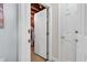 Unfinished attic access through a white door at 3271 Johnstowne St, Johns Island, SC 29455