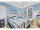 Cozy bedroom with blue walls, queen-sized bed, and sunny window at 3271 Johnstowne St, Johns Island, SC 29455