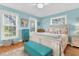Cozy bedroom with hardwood floors, large windows, a white bed frame, and blue accents at 3271 Johnstowne St, Johns Island, SC 29455