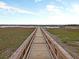 Picturesque wooden boardwalk extending over serene marshlands, inviting peaceful strolls and scenic waterfront views at 3271 Johnstowne St, Johns Island, SC 29455