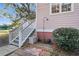 Exterior stairs on a pink home with an outdoor shower and Welcome mat at 3271 Johnstowne St, Johns Island, SC 29455