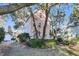 Charming two-story pink home with a front porch nestled among lush trees and greenery at 3271 Johnstowne St, Johns Island, SC 29455