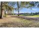 Scenic view of the golf course with lush green grass and mature trees under a clear blue sky at 3271 Johnstowne St, Johns Island, SC 29455