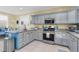 Well-equipped kitchen featuring a stainless steel range, and gray cabinets with granite countertops at 3271 Johnstowne St, Johns Island, SC 29455