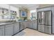 Modern kitchen featuring stainless steel appliances, gray cabinets, and a view to the exterior at 3271 Johnstowne St, Johns Island, SC 29455