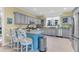 Spacious kitchen with gray cabinets, granite countertops, stainless steel appliances, and breakfast bar seating at 3271 Johnstowne St, Johns Island, SC 29455