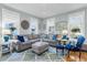 Bright living room featuring a plush sectional sofa, accent chair, and a soft blue patterned rug at 3271 Johnstowne St, Johns Island, SC 29455