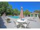 A community pool is surrounded by lounge chairs and an outdoor seating area with tables and umbrellas at 3271 Johnstowne St, Johns Island, SC 29455