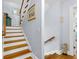 Bright staircase featuring hardwood steps, white risers, and decorative wall art at 3271 Johnstowne St, Johns Island, SC 29455