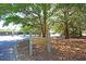 Signage for the Fred Nista Tennis Center in a wooded area with parking and shade at 3271 Johnstowne St, Johns Island, SC 29455