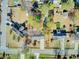 Bird's eye view of homes showcasing solar panels and backyard pools surrounded by lush greenery at 3360 Pinewood Dr, Ladson, SC 29456