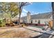 The backyard of this home has a gravel area and a grassy yard at 3360 Pinewood Dr, Ladson, SC 29456