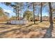 This expansive backyard is framed by mature trees and features a pool, creating a private outdoor oasis at 3360 Pinewood Dr, Ladson, SC 29456