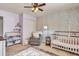 Bright Bedroom with stylish decor, a crib, and a cozy chair at 3360 Pinewood Dr, Ladson, SC 29456