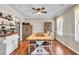 Dining room with wood floors, modern light fixture, and view into the kitchen at 3360 Pinewood Dr, Ladson, SC 29456