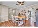 Open-concept dining room with wood floors, stylish table, and seamless flow to the kitchen at 3360 Pinewood Dr, Ladson, SC 29456