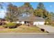 Charming ranch home with well-manicured lawn, mature trees, and attached two-car garage at 3360 Pinewood Dr, Ladson, SC 29456