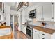 Galley kitchen featuring a wood countertop, stainless steel appliances, and white cabinetry at 3360 Pinewood Dr, Ladson, SC 29456