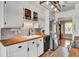 Galley kitchen with wood countertops, stainless steel appliances, and white cabinets at 3360 Pinewood Dr, Ladson, SC 29456
