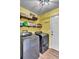 Well-lit laundry room with yellow walls and stainless steel washer and dryer at 3360 Pinewood Dr, Ladson, SC 29456