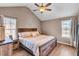 Comfortable main bedroom featuring a wood-look floor, ceiling fan, and large windows at 3360 Pinewood Dr, Ladson, SC 29456